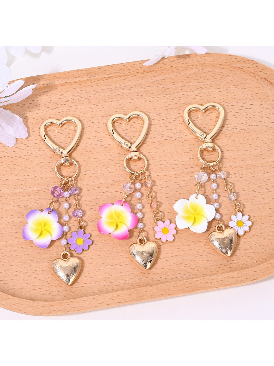 Heart-shaped flower bag charm keychain in red with gold hardware