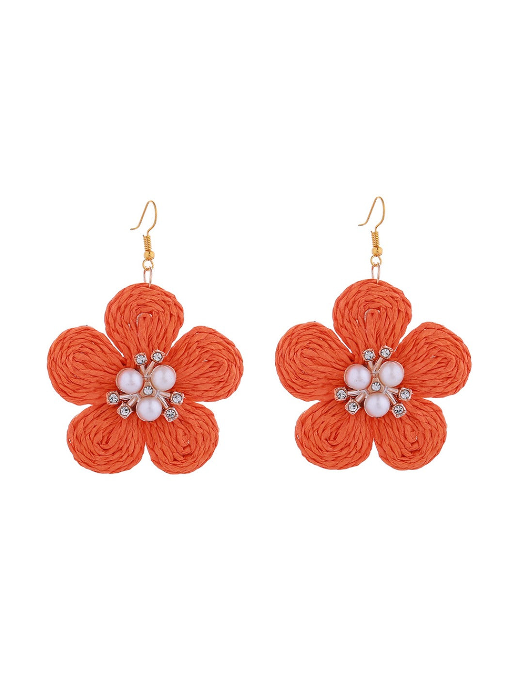 Detailed shot of raffia fibers in flower-shaped earrings showing craftsmanship and texture