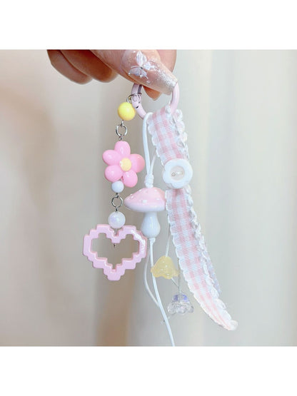 Pink mushroom keychain displayed against a white background with soft shadows