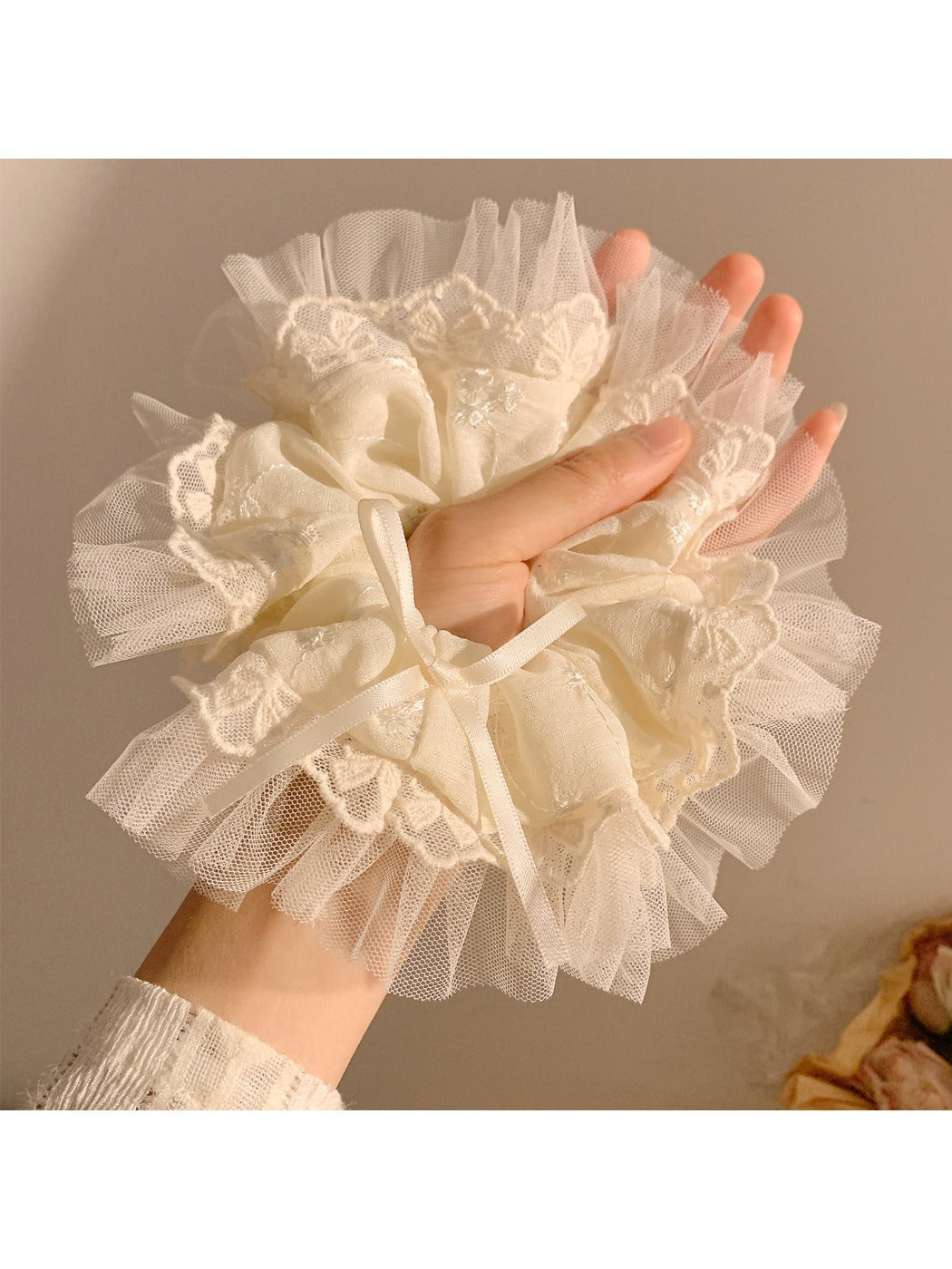 Close-up of Gifty bow scrunchie showing fabric texture and bow detail