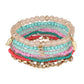 Lovra bracelets stacked on wrist with a blurred outdoor background