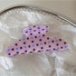 Beau pink polka dot hair clip shown from the back with metal clip visible