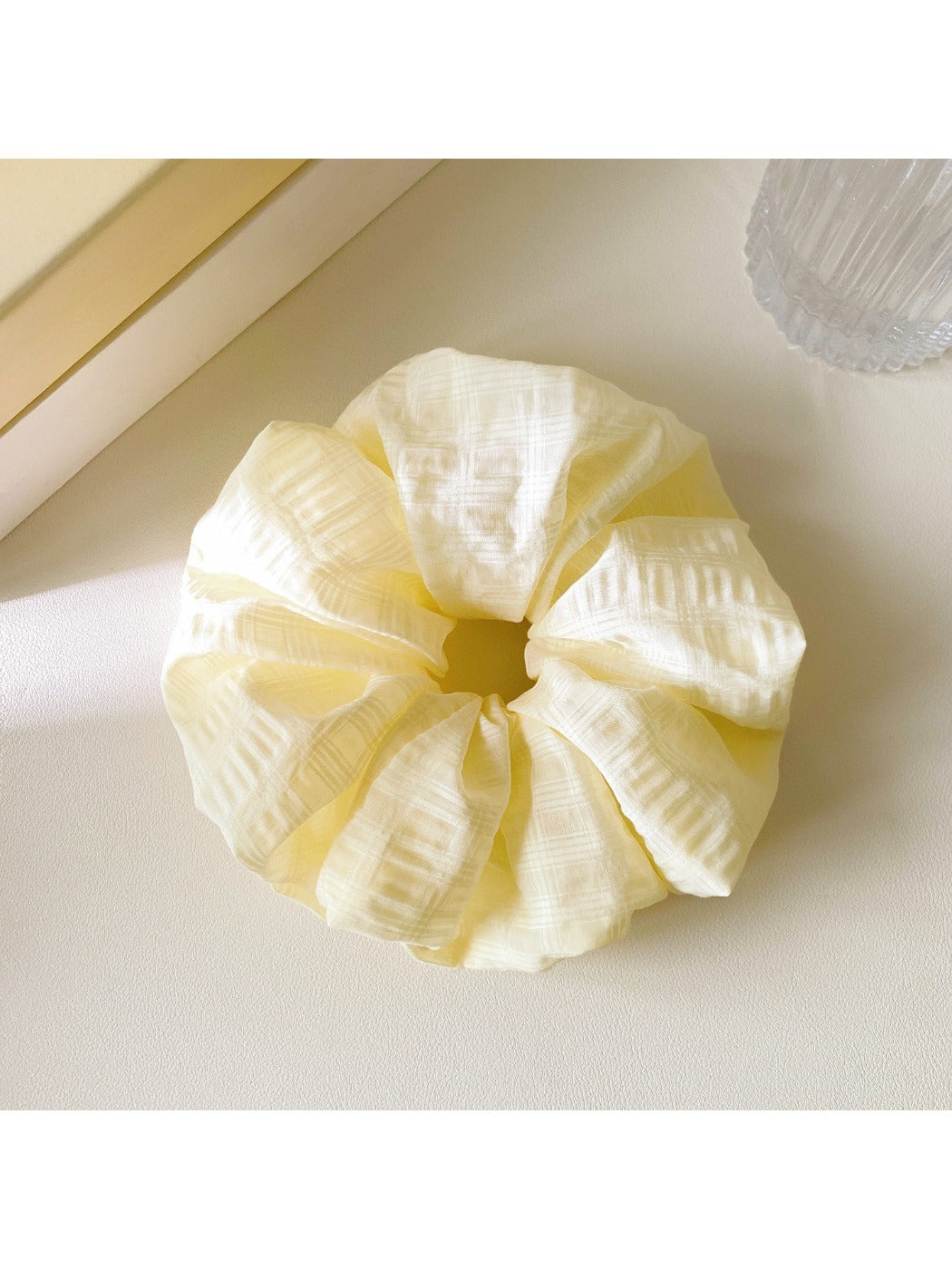 Gifty scrunchie wrapped around a ponytail, highlighting its stretch and colorful design
