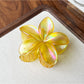 Beau flower shaped claw clip shown from top angle highlighting flower design