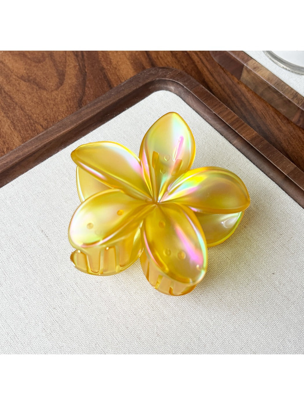 Beau flower shaped claw clip shown from top angle highlighting flower design
