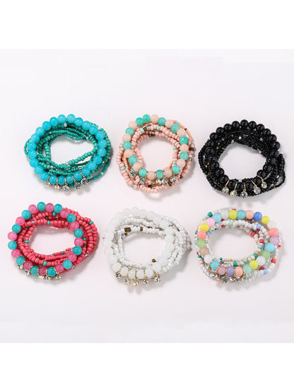 Lovra rhinestone pendant with colorful beaded bracelet on white background