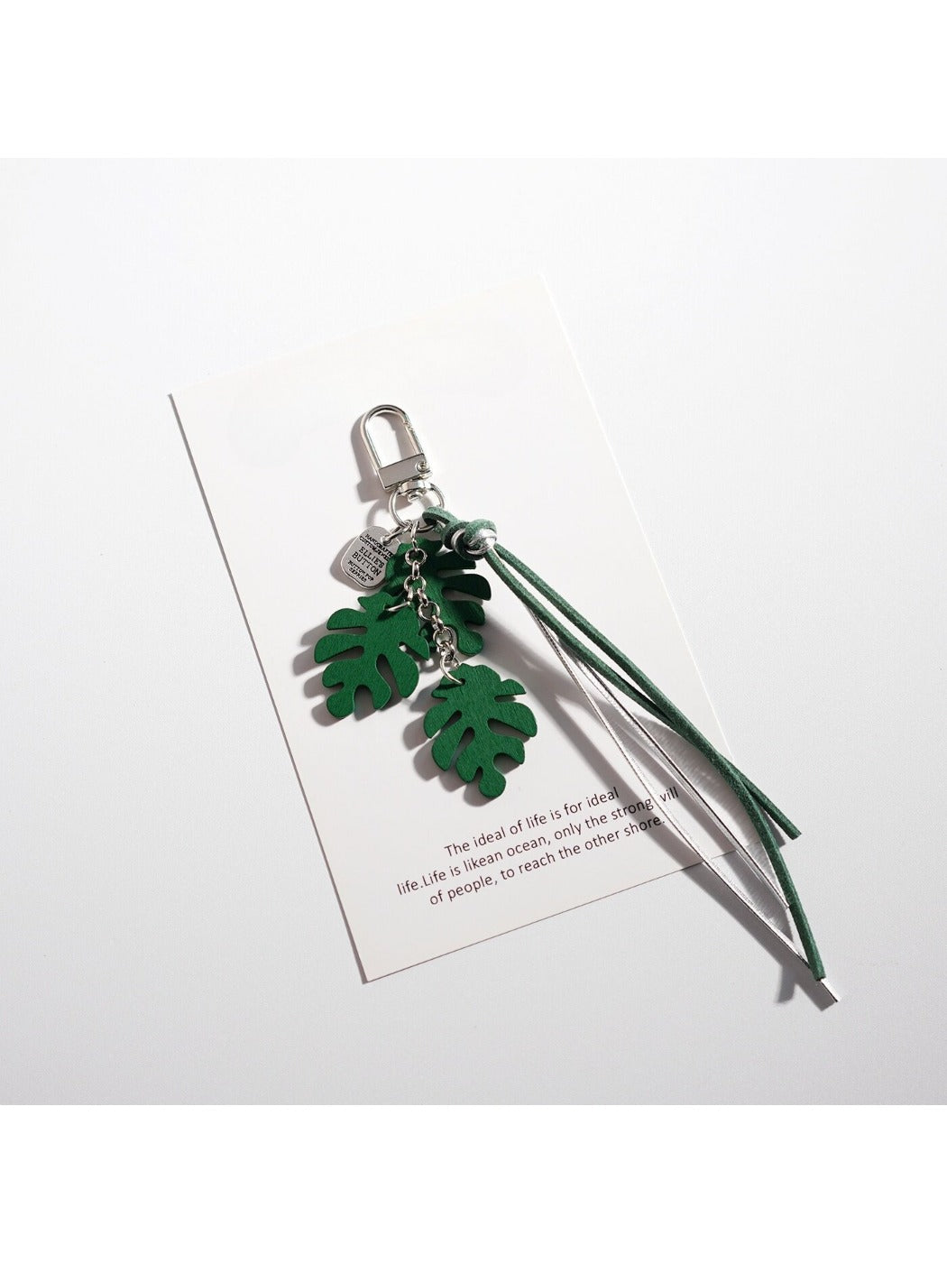 Keypus leaf shaped keychain with intricate leaf vein design on a table
