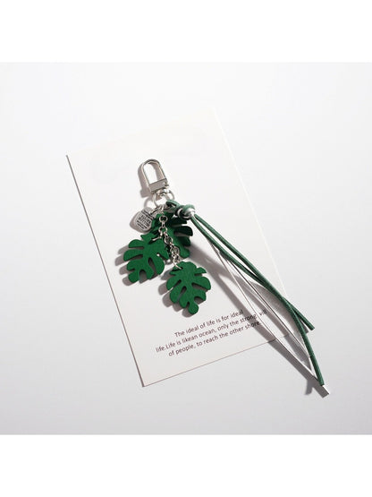 Keypus leaf shaped keychain with intricate leaf vein design on a table