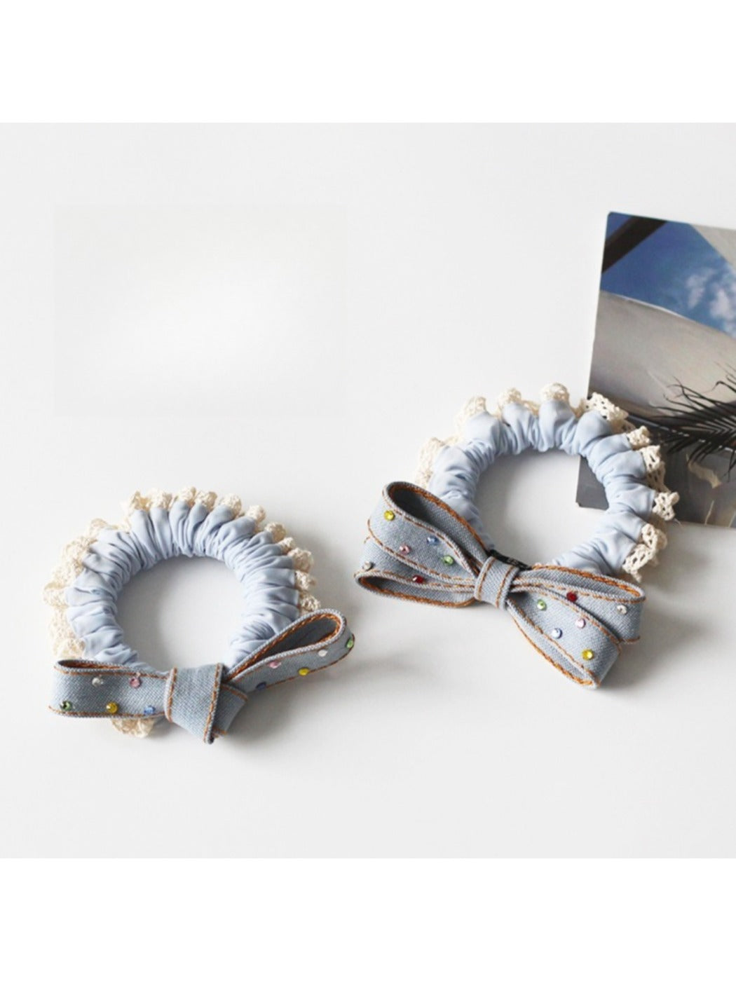 Set of colorful bow hair ties arranged in a circle on a wooden surface