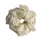 Close-up of delicate white tulle fabric scrunchie featuring small floral prints