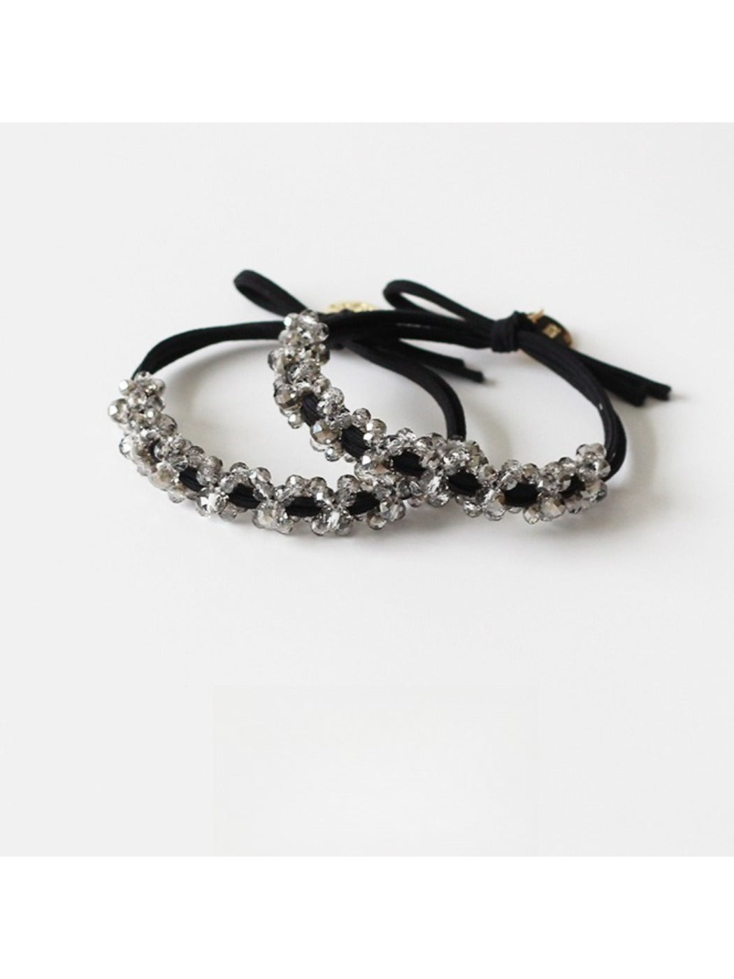 Close-up of Gifty minimalist modern beaded hair tie with small round beads on elastic band