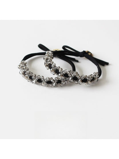Close-up of Gifty minimalist modern beaded hair tie with small round beads on elastic band