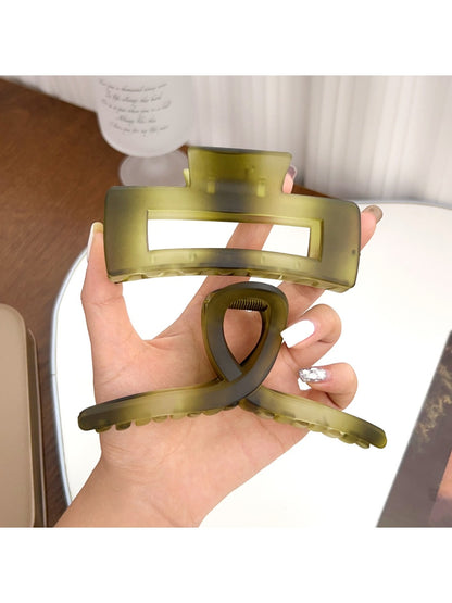 Beau hair claw clip holding thick brown hair in a half-up style