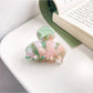 Top view of Beau vintage small crescent shaped claw clip showing smooth glossy finish