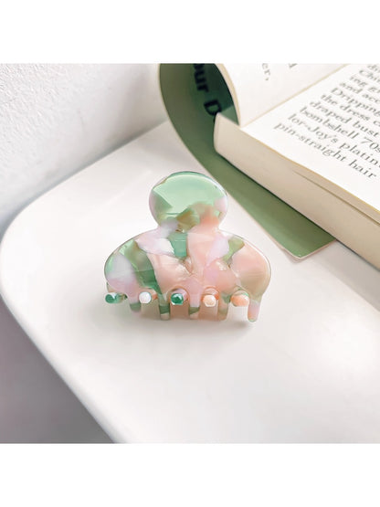 Top view of Beau vintage small crescent shaped claw clip showing smooth glossy finish