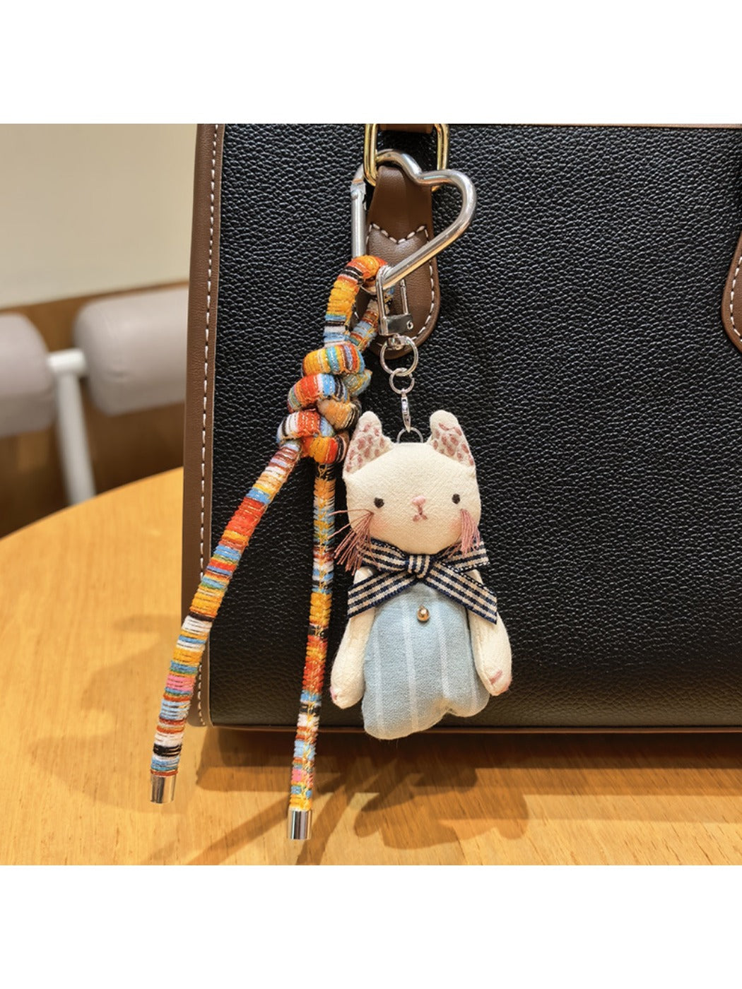 Classic cat charm keychain displayed on a wooden surface