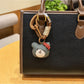 Bear charm keychain with a small bell attached to the keyring