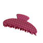Beau colorful polka dot hair clip held in hand showing size and detail
