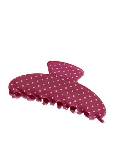 Beau colorful polka dot hair clip held in hand showing size and detail