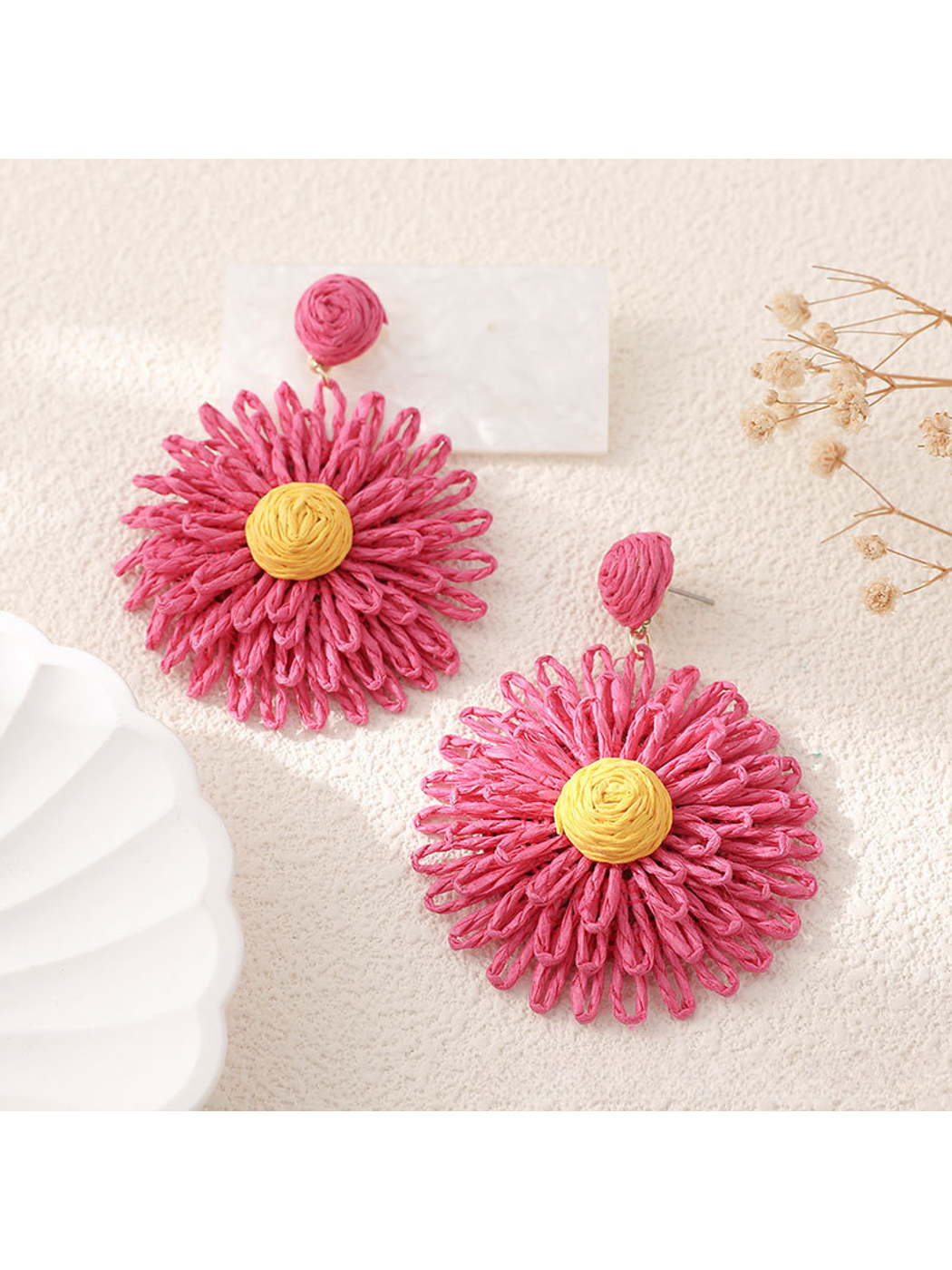 Detailed shot of colorful raffia strands forming floral pattern on earrings