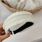 Top view of Gifty headband displaying its symmetrical bow and smooth finish