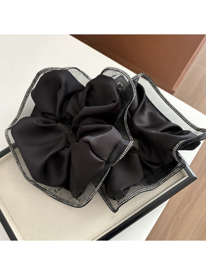 Gifty chic minimalist aesthetic scrunchie in soft beige fabric on white background