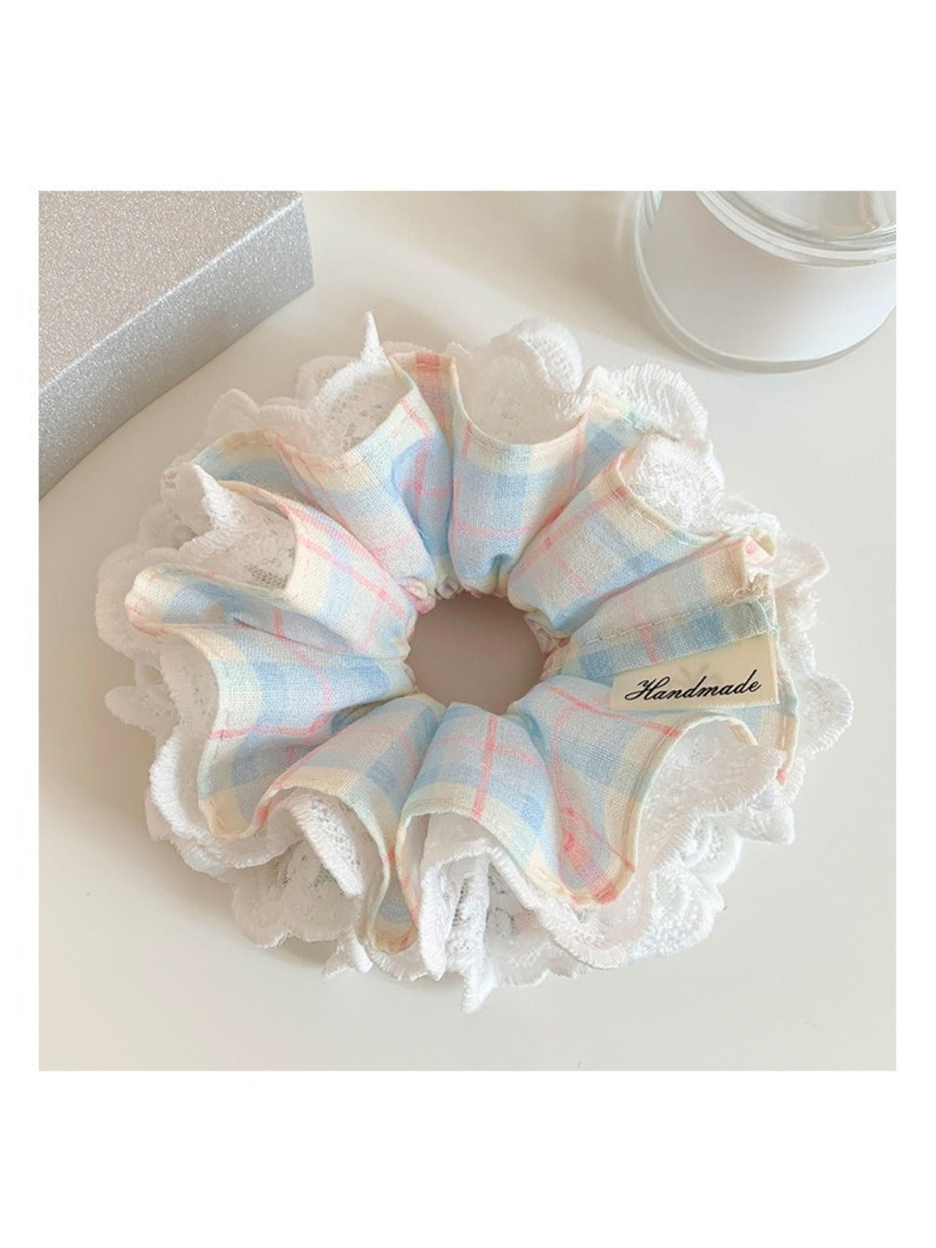 Blue plaid scrunchie with lace trim displayed flat showing full pattern