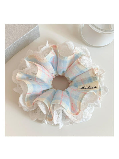 Blue plaid scrunchie with lace trim displayed flat showing full pattern