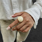 Lovra open cuff ring worn on hand with neutral background