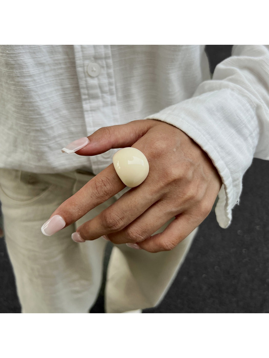 Lovra open cuff ring worn on hand with neutral background