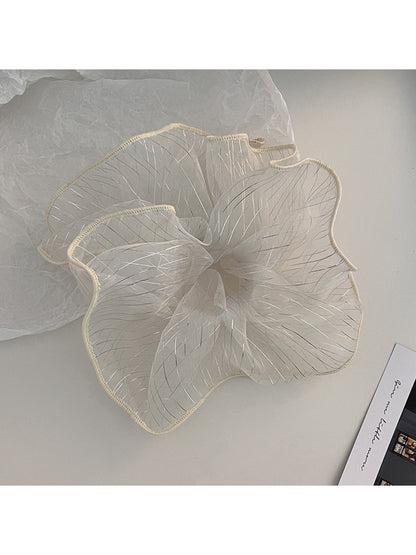 Flat lay of Gifty pleated scrunchie on a white background highlighting its elegant design