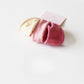 Individual hair tie laid flat to show thickness and fabric detail