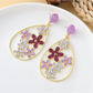 Earedge floral raffia earrings styled with casual summer outfit on model