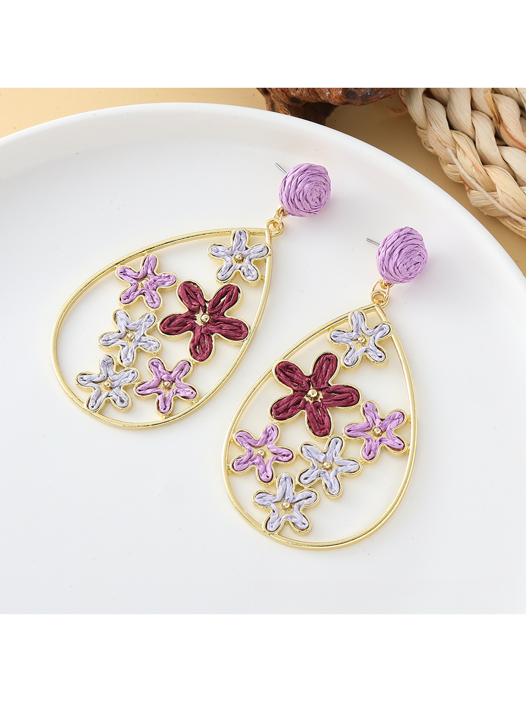 Earedge floral raffia earrings styled with casual summer outfit on model