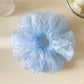 Gifty polka dot scrunchie styled on a wrist as a fashion accessory