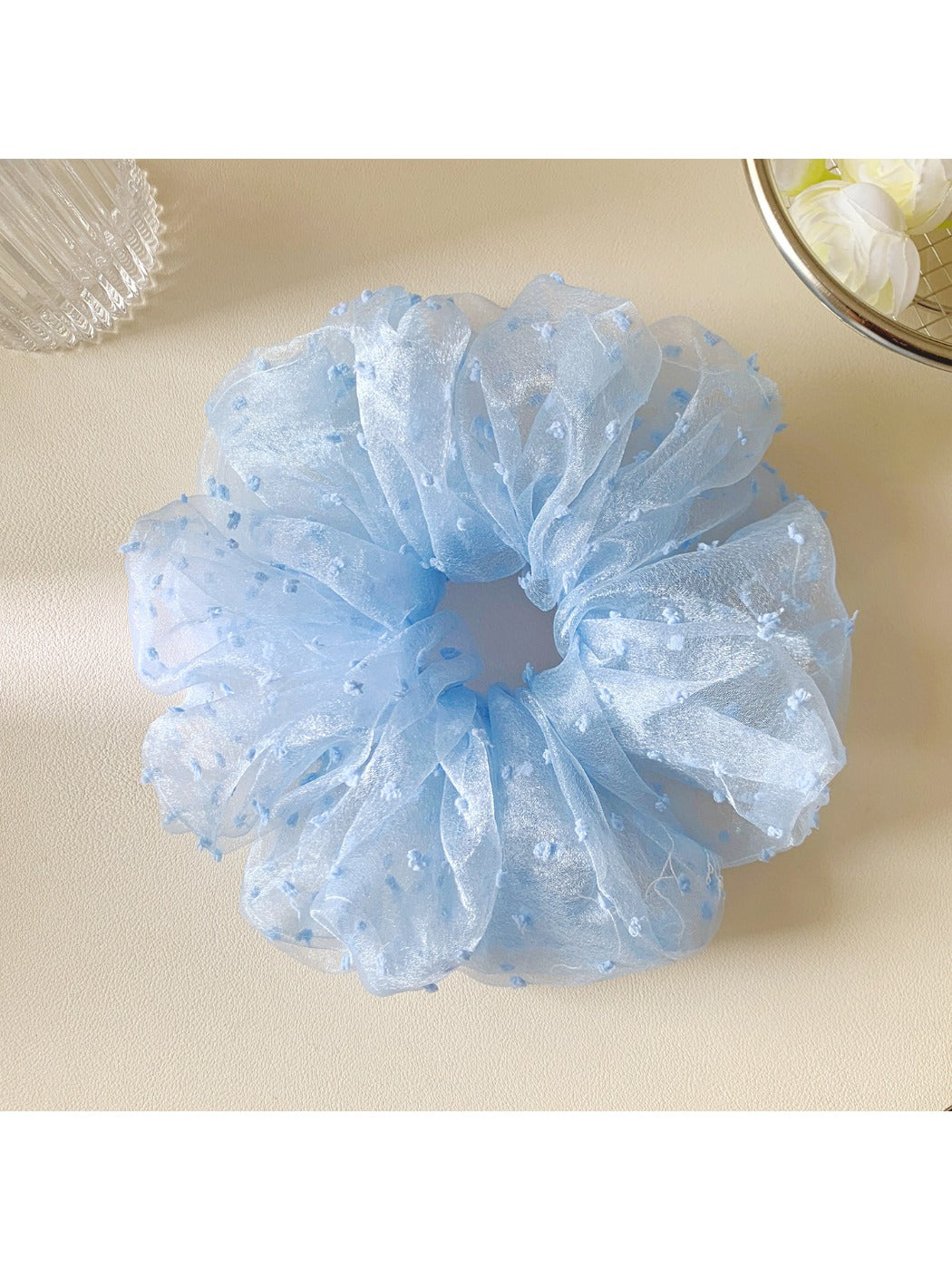 Gifty polka dot scrunchie styled on a wrist as a fashion accessory