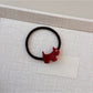 Gifty cartoon puppy hair tie stretched to show elasticity and charm details