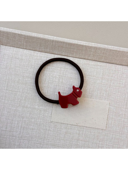 Gifty cartoon puppy hair tie stretched to show elasticity and charm details