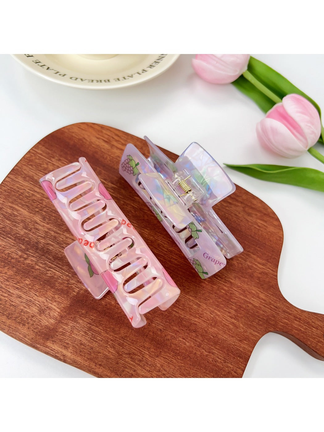 Side view of Beau square claw clip highlighting the clip mechanism and fruit pattern