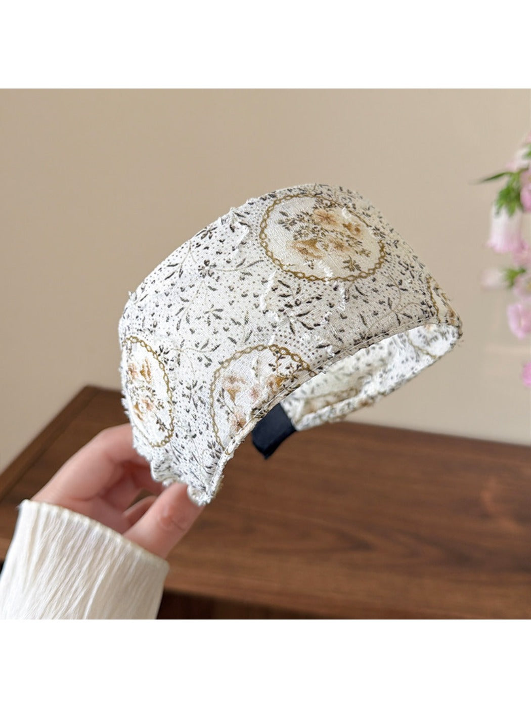 Side view of countryside style headband worn on a model with loose hair