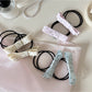 Gifty hair tie with a large pink bow embellishment on a white background