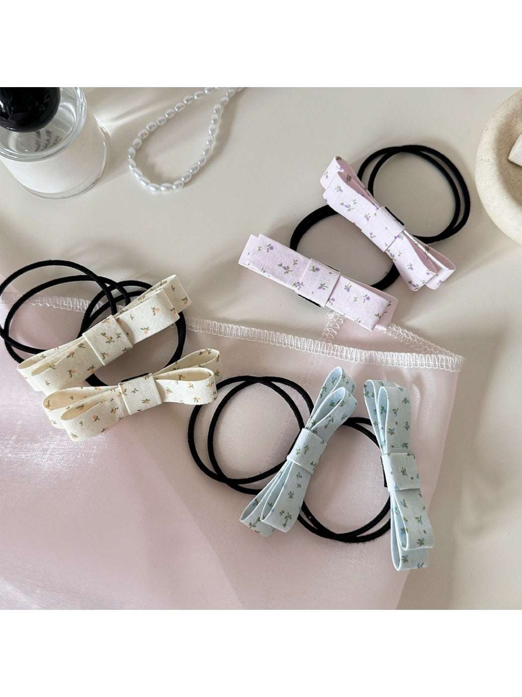 Gifty hair tie with a large pink bow embellishment on a white background