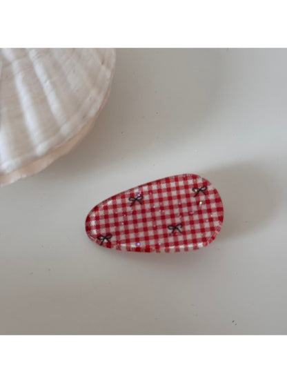 Beau hair clip displayed on a wooden surface emphasizing its sophisticated vintage vibe