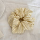 Yellow striped scrunchie displayed flat showing full pattern and shape