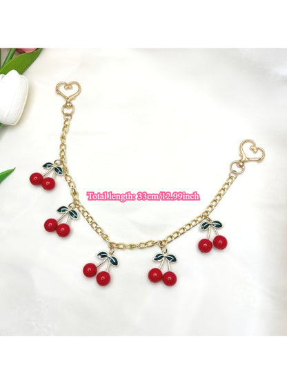 Top view of the cherry charm with silver keyring and green leaf accent