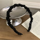 Side view of the Gifty elegant headband highlighting its curved shape and bead details