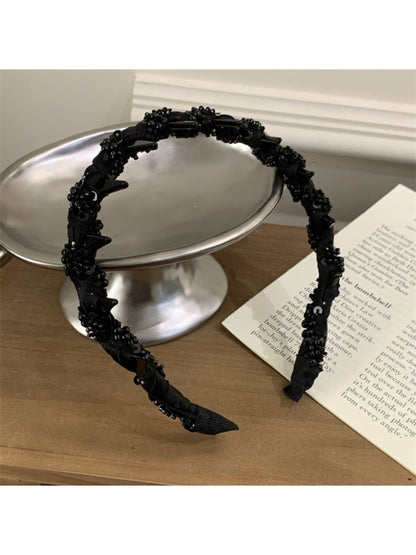 Side view of the Gifty elegant headband highlighting its curved shape and bead details