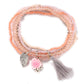 Lovra bracelet with flower pendant placed next to matching jewelry pieces