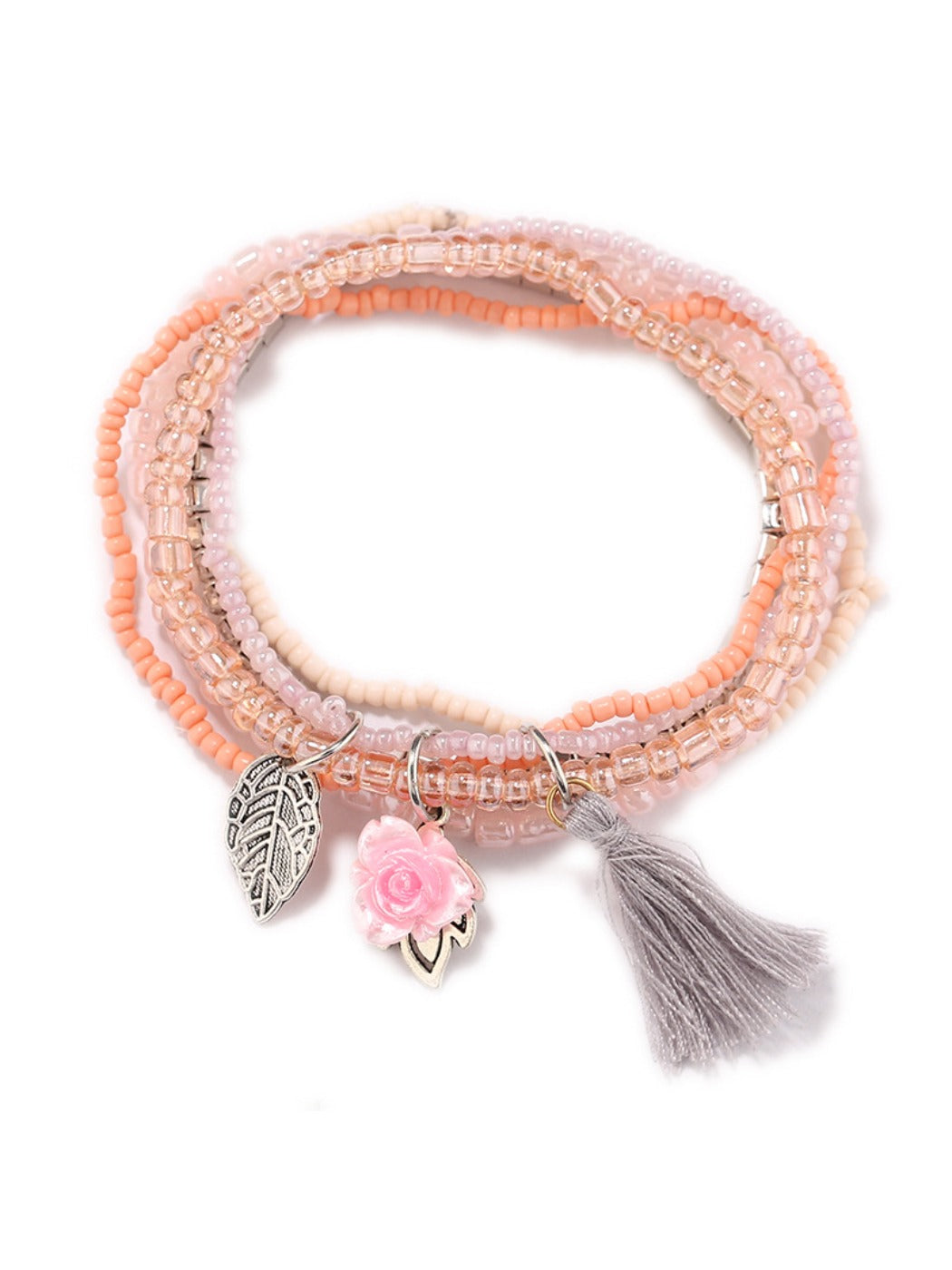 Lovra bracelet with flower pendant placed next to matching jewelry pieces