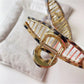 Beau vintage crisscross hair claw clip holding long hair in a half-up style